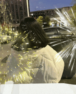 a girl in a white jacket stands in front of a car with a sign that says ' e best car ' on it