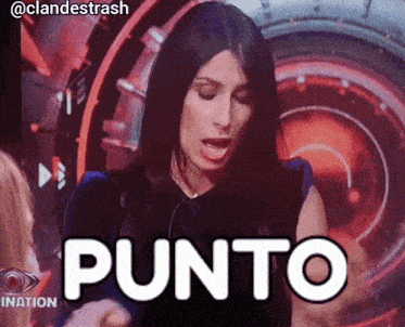 a woman says punto in front of a big brother screen