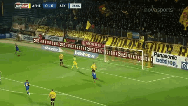 a soccer game is being played in a stadium with advertisements for panasonic and morris