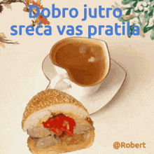 a sandwich and a cup of coffee on a saucer