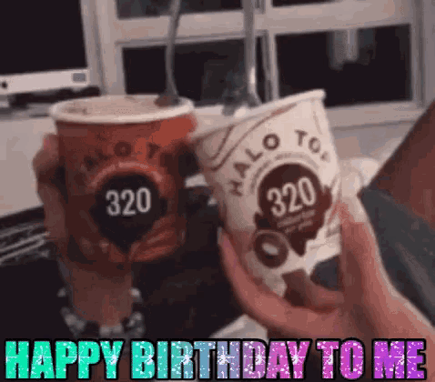 two cups of halo top ice cream are being held in someone 's hands