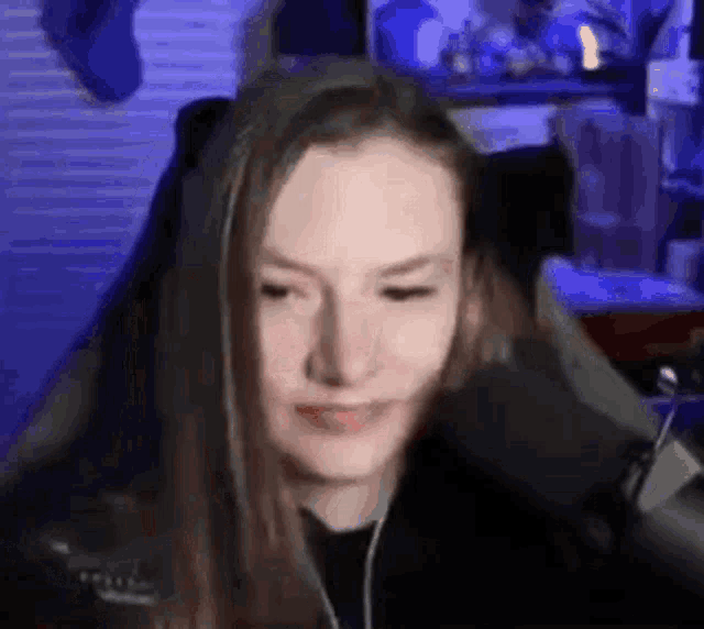 a woman is sitting in a chair in front of a microphone in a room .