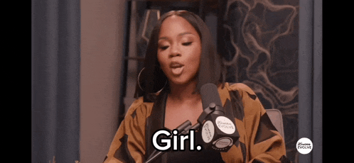 a woman speaking into a microphone with the word girl on her face