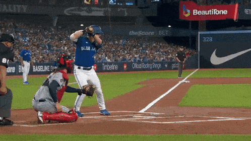 a blue jays baseball player getting ready to hit a ball