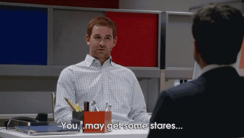 a man sitting at a desk talking to another man with the words you may get some stares below him