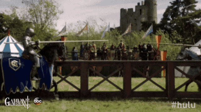 a knight on a horse in a field with a castle in the background and #hulu on the bottom