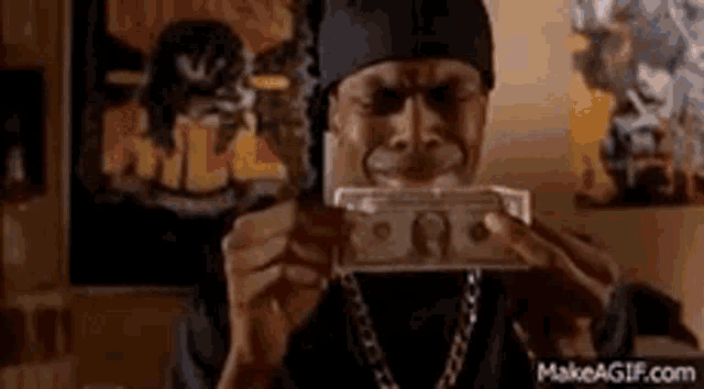 a man is holding a bunch of money in his hands .