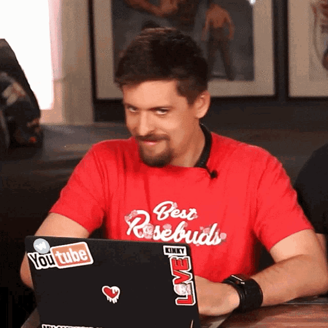 a man wearing a red shirt with the word best on it