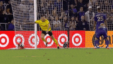 a soccer player with the number 25 on his jersey is jumping in the air