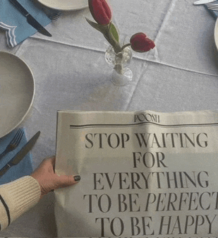 a person holding a sign that says stop waiting for everything to be perfect to be happy