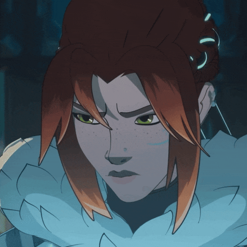 a close up of a person 's face with red hair and green eyes