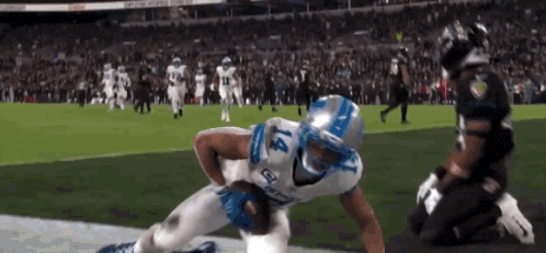 a football player with the number 4 on his jersey runs with the ball