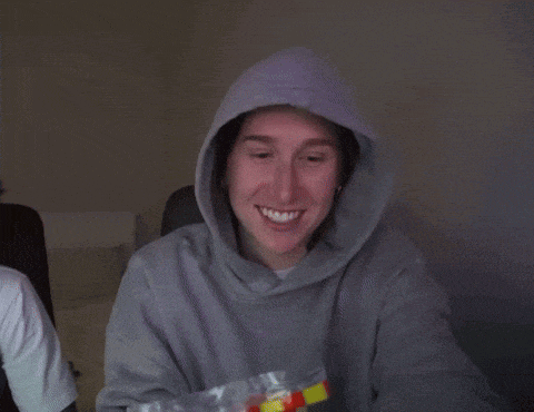 a person in a hoodie holds a bag of mcdonald 's hot dogs
