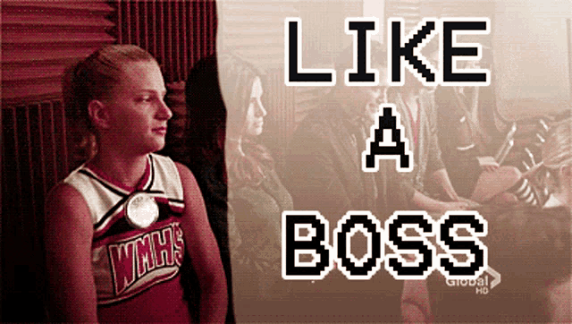 a cheerleader wearing a wmhs jersey is standing in front of a sign that says " like a boss "