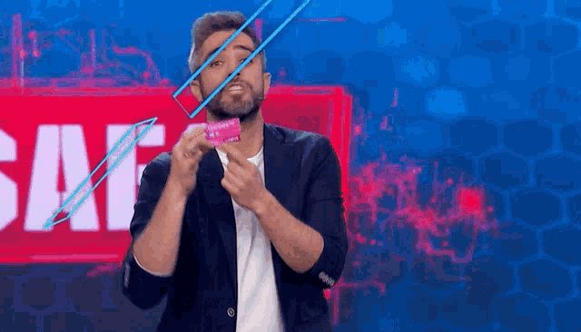 a man with a beard is holding a condom in front of a sign that says sale