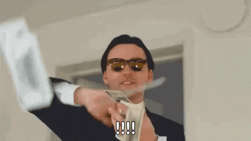 a man in a suit and sunglasses is throwing a bunch of money into the air .