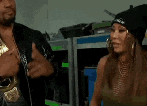 a man and a woman are standing next to each other and the woman is wearing a beanie .