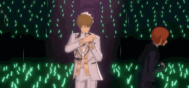a man in a white suit is singing into a microphone in front of a crowd