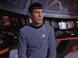 a man in a blue shirt with a star trek logo on his chest