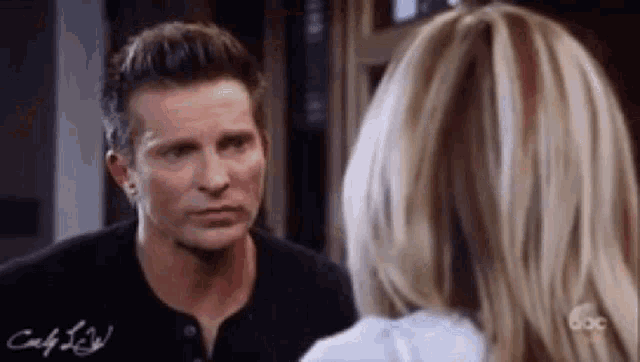 a man and a woman are looking into each other 's eyes .