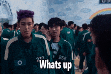 a group of people are standing in a room and one of them is wearing a uniform with the number 256 on it