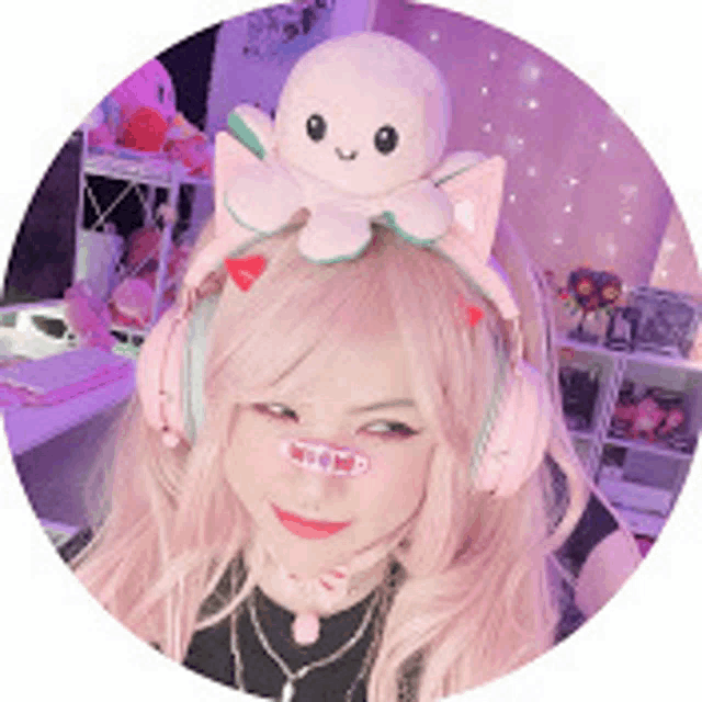 a woman is wearing headphones and a headband with an octopus on it .