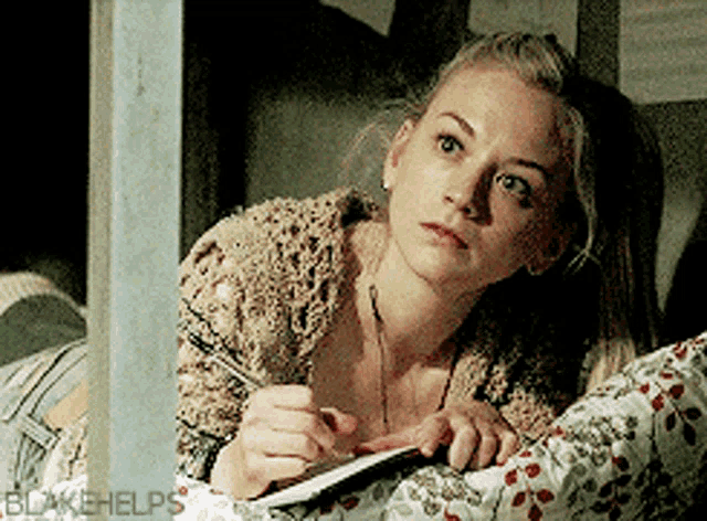 a woman is writing on a piece of paper with blakehelps written on the bottom right