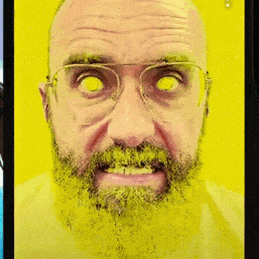a man with glasses and a green beard has glowing yellow eyes