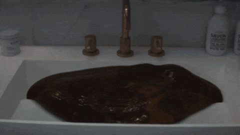 a bathroom sink with a bottle of savon liquide on the counter
