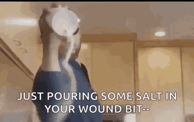 a man is pouring some salt into a wound .