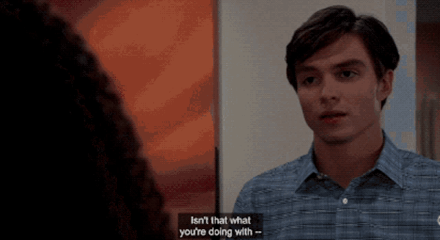 a man in a plaid shirt is talking to a woman who says " isn 't that what you 're doing "