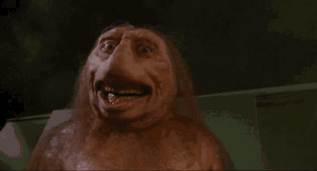 a close up of a monster 's face in a movie with smoke coming out of it 's mouth .