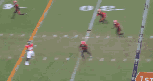a football game is being played on a field with the number 30 on the sidelines