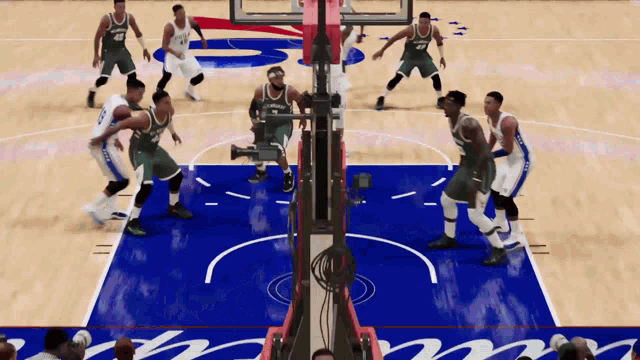 a group of basketball players are playing on a court with the word bucks on the wall