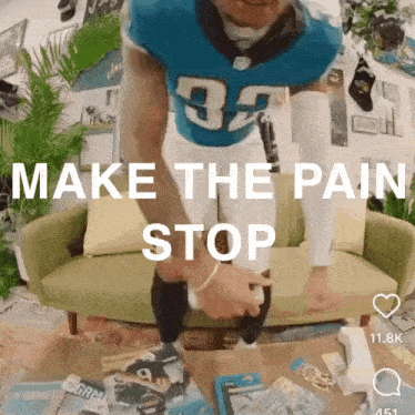 a man in a jaguars jersey is standing in front of a couch