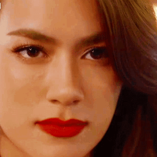 a close up of a woman with red lipstick on her lips