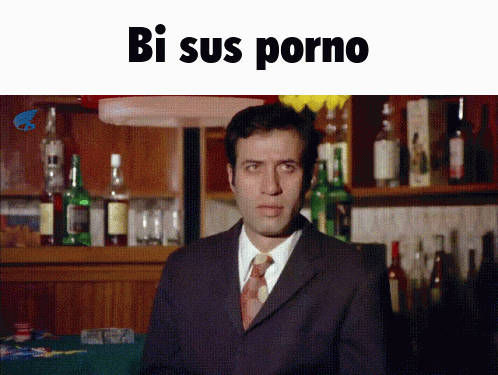 a man in a suit and tie is standing in front of a bar with the words bi sus porno written above him