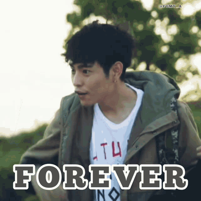 a man wearing a jacket and a t-shirt with the word forever on it