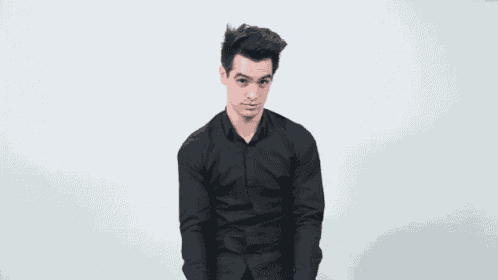 a man in a black shirt is holding a piece of paper .