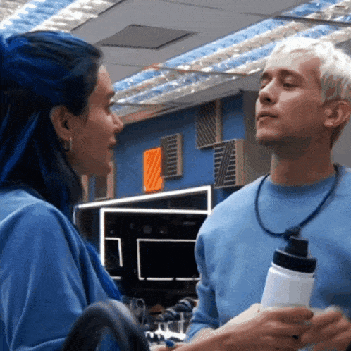 a man and a woman are looking at each other