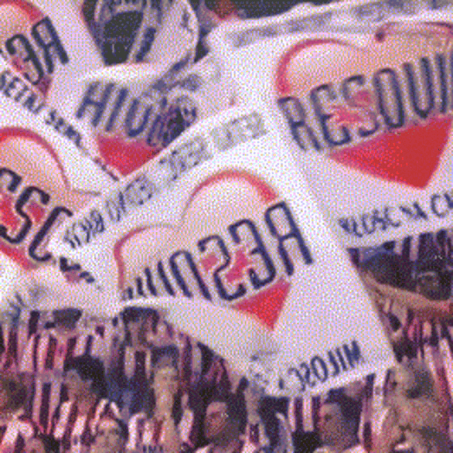a crowd of people holding up flags with hearts and the letters esc on them