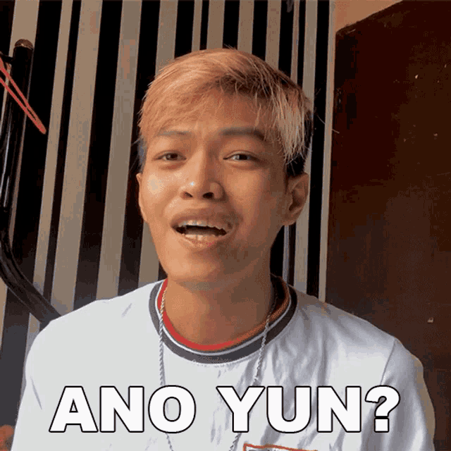 a young man wearing a white shirt that says ano yun on it