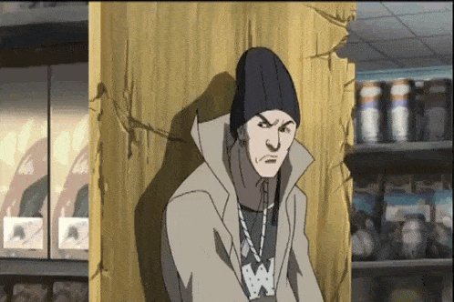 a man in a beanie is leaning against a wall in front of a store shelf .