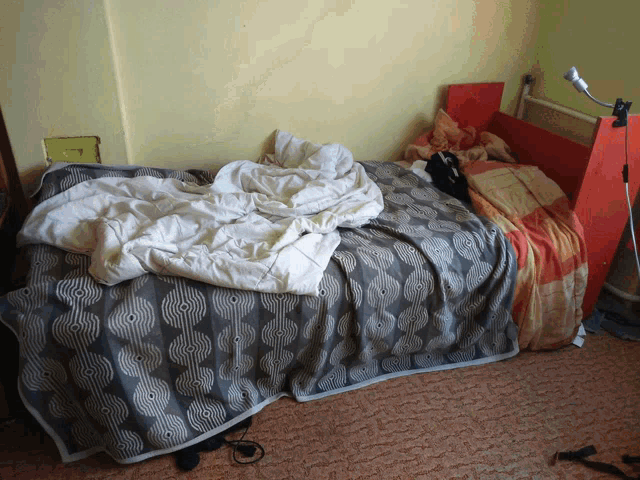 a bed with a blanket that has a pattern of circles on it