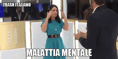 a woman in a blue dress is standing next to a man in a suit and the words malatia mentale are on the screen