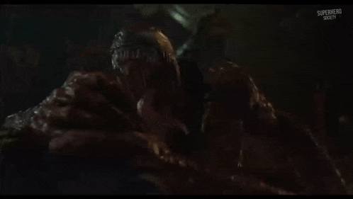 a dark room with a superhero written on the bottom of the screen