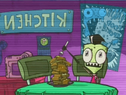 a cartoon character sits at a table in front of a sign that says kiichem