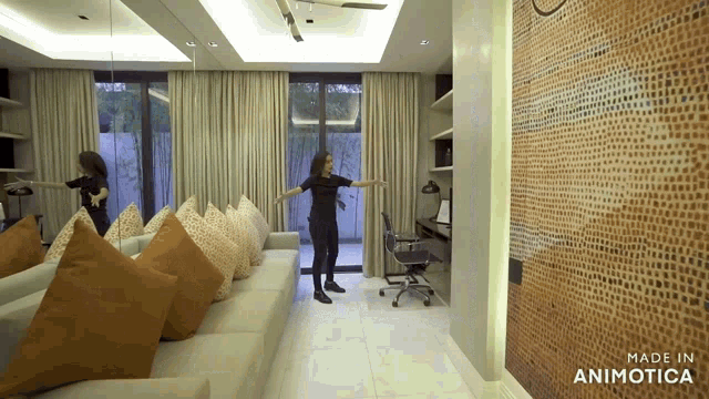 a woman is standing in a living room with the words made in animotica on the bottom
