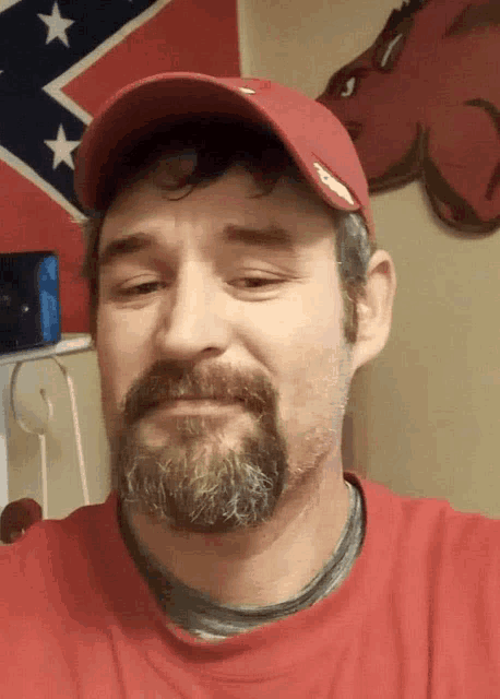 a man with a beard wearing a red hat