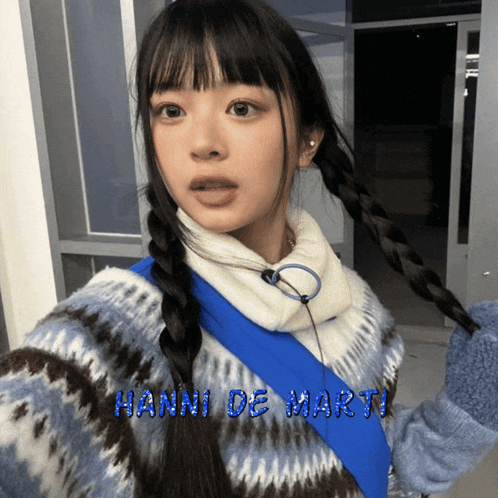 a girl wearing a sweater with the name hanni de marty on it